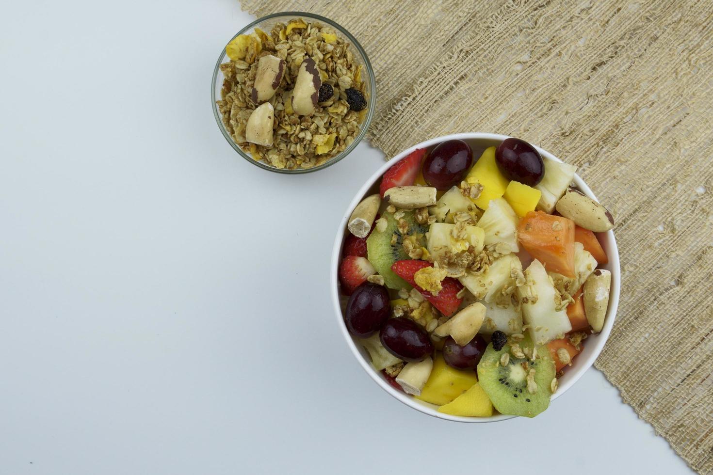 Fruit salad with chestnuts and granola in a bowl photo