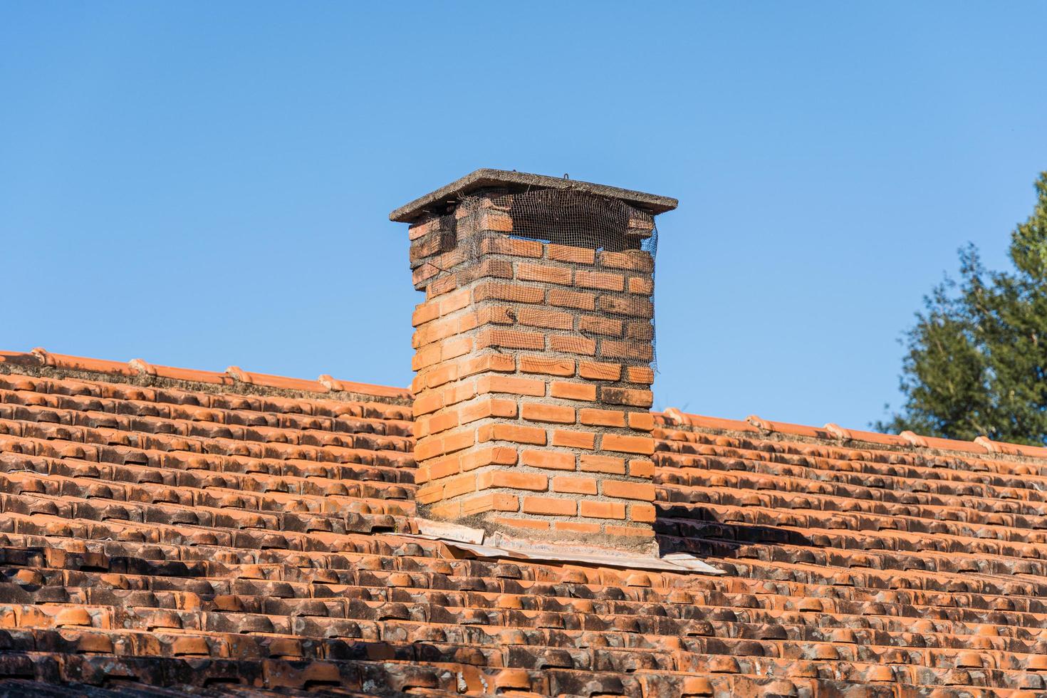 Roof with tiles and red chimney in the interior of brazil photo