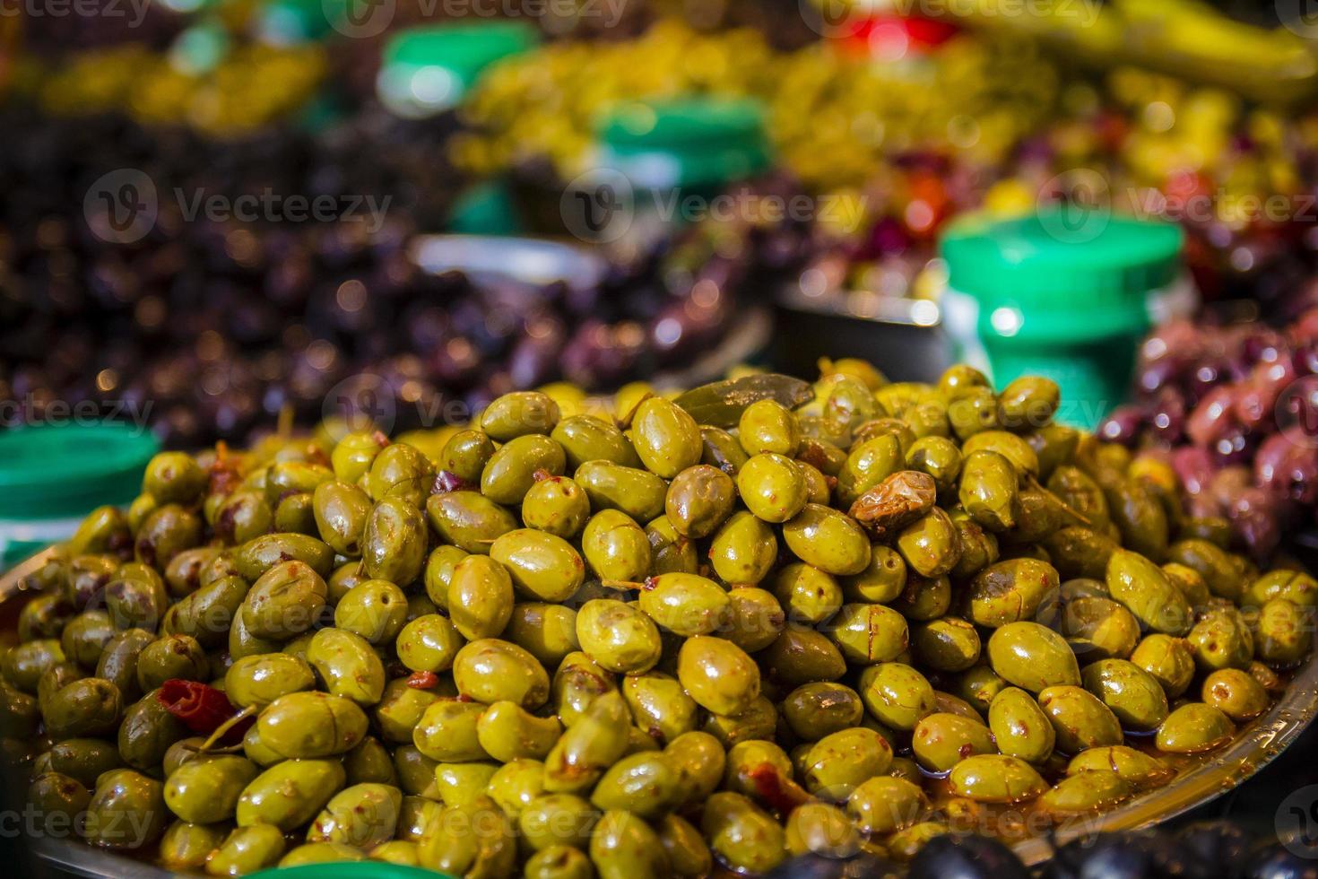 Olives at a market stall. A variety of types of olives photo