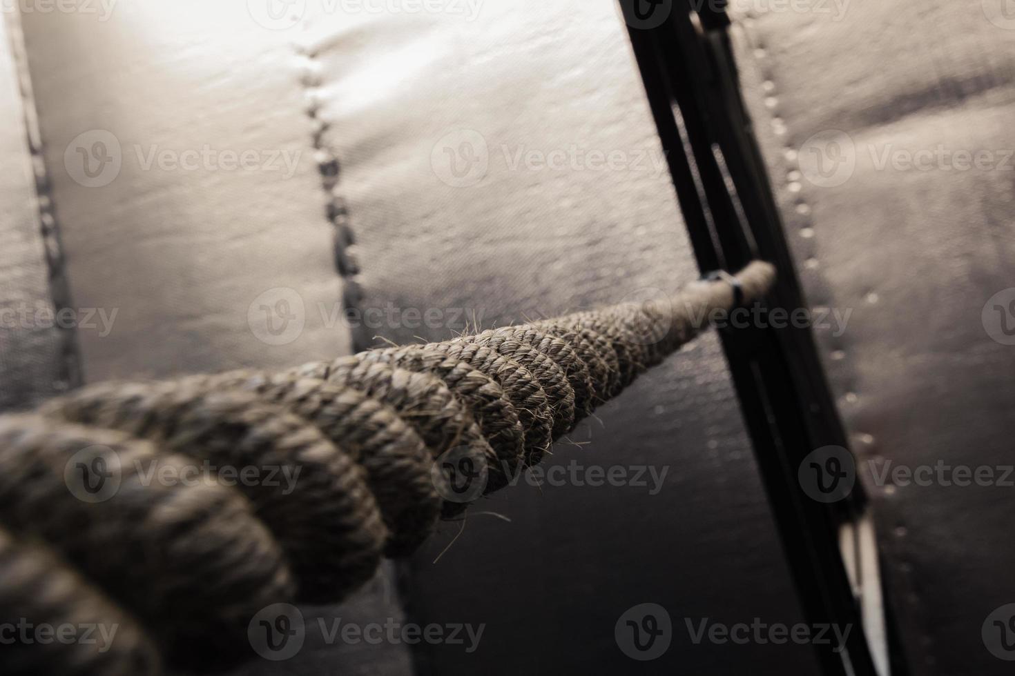 Brown climbing rope hanging from roof photo