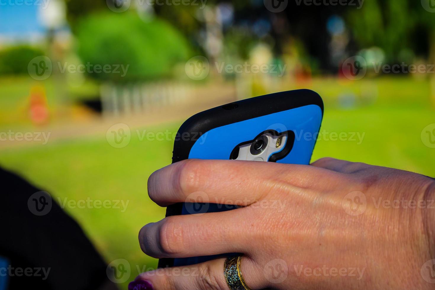 Close up of woman holding smartphone with her hand photo