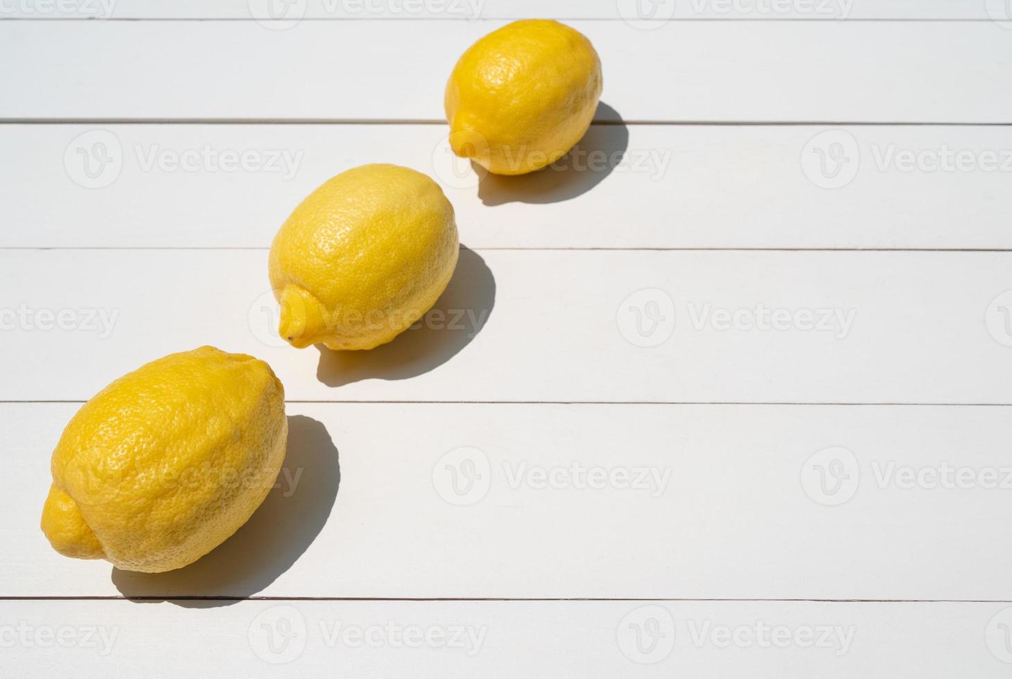 view from above of fresh lemon on whte table photo