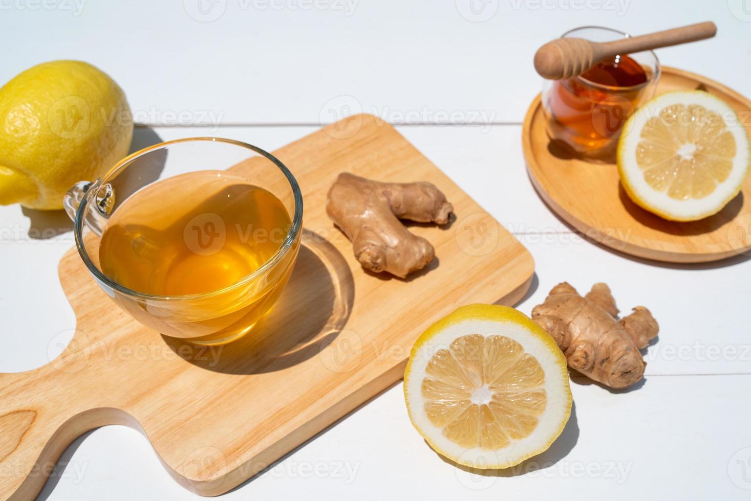 hot tea with honey and ginger served on table in cafe photo