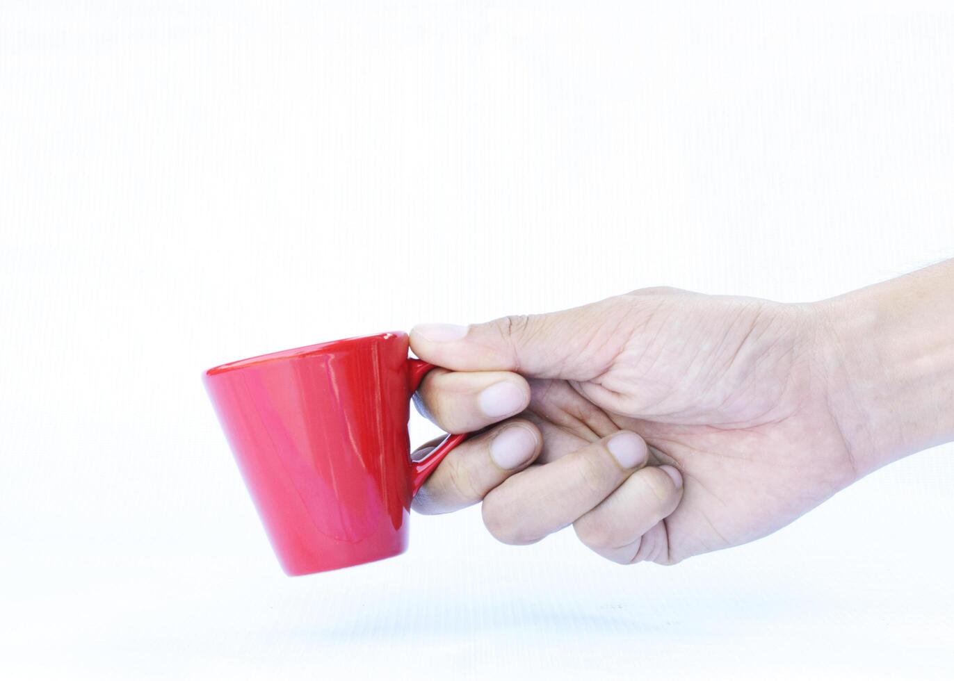 Hand holding Red Cups Isolated on white backgrounds photo