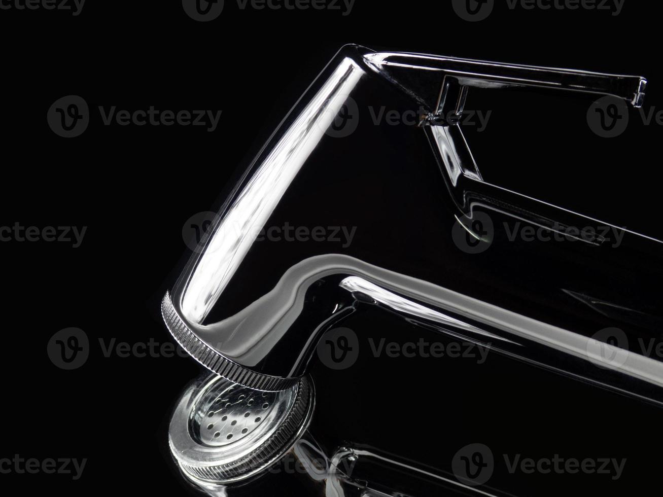 Closeup Bidet shower material and spiral pipe. The design concept is based on a mirror background with a black tone that is highly shiny and expensive. Butt cleaning equipment in the bathroom photo