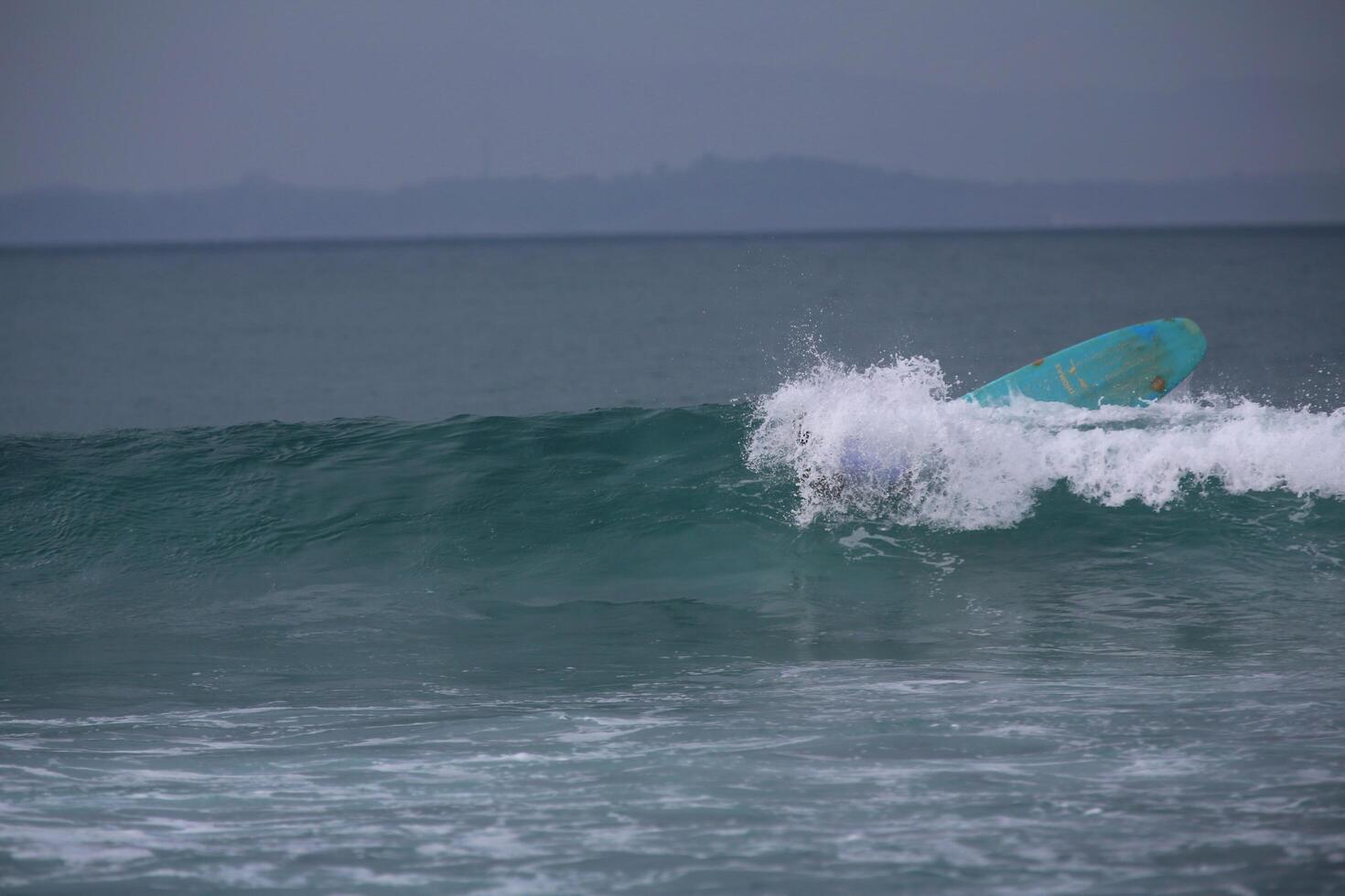 tabla de surf inversa en el océano foto