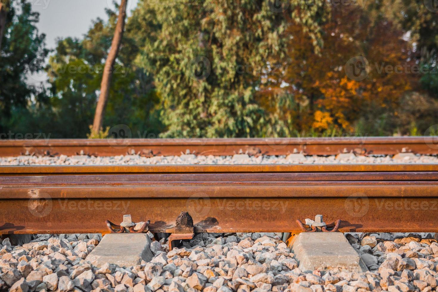 Railroad track in a rural area in the afternoon photo