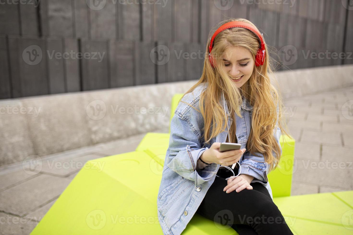 Young woman listen music from mobile phone photo