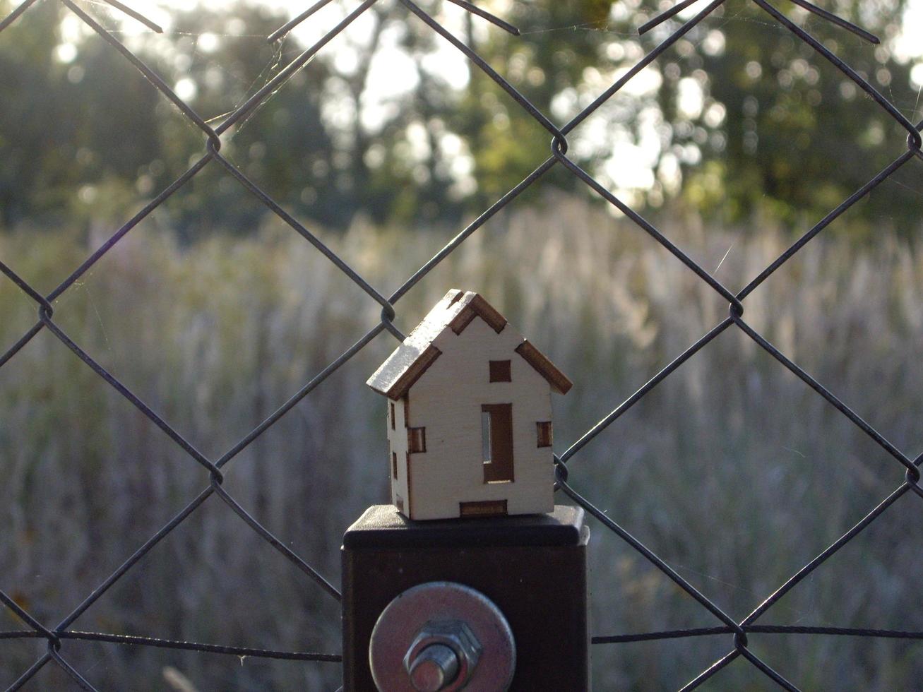 Mockup of a small wooden house on the background of the village photo