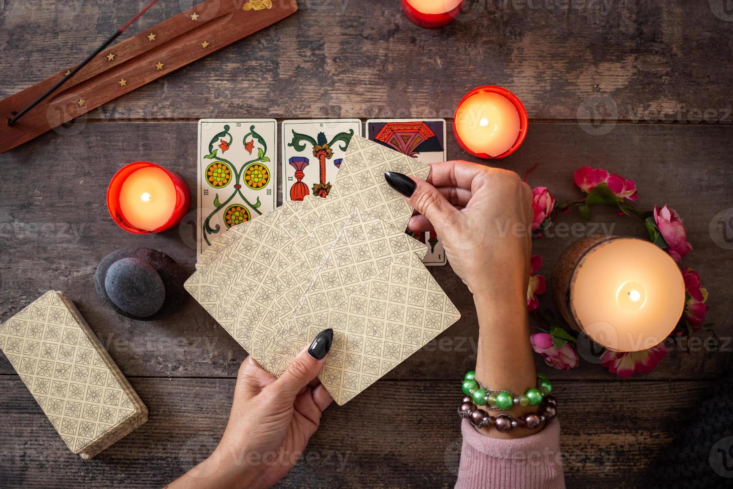 Fortune teller reading a future by tarot cards photo