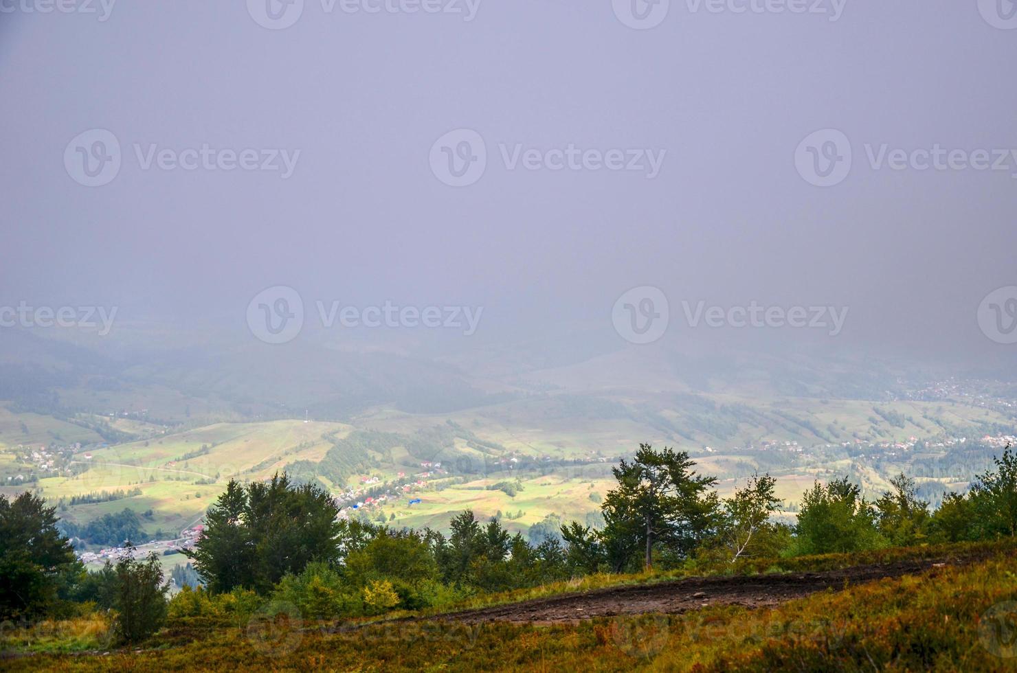 View of village covered in fog at Carpathian mountains photo