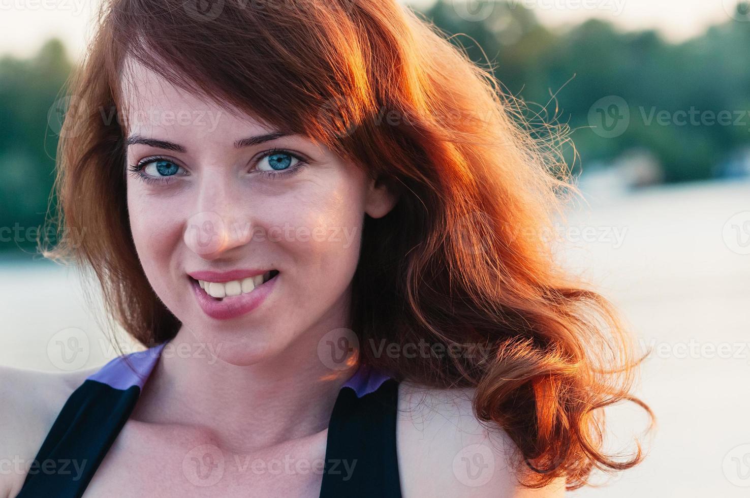 Portrait of pretty girl truly smiling, on summer nature background photo