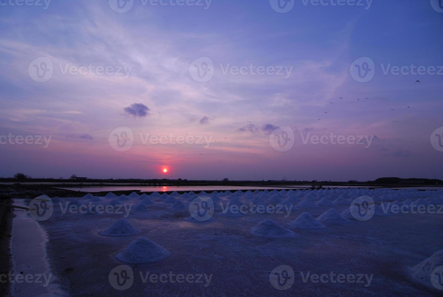 Beautiful sunset salt farming Naklua in the coastal, Phetchaburi provinces of Thailand photo