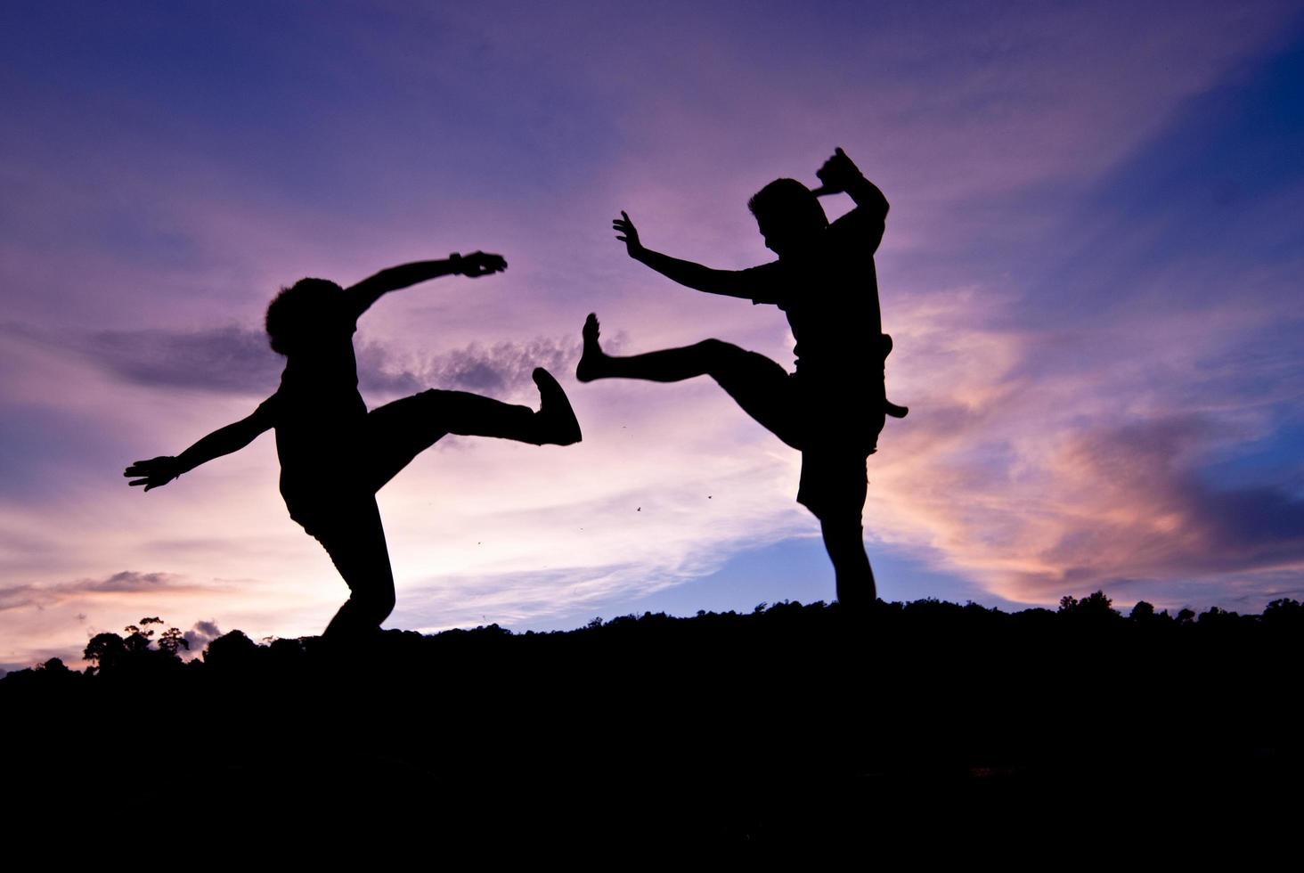 Silhouette happy jumping against beautiful in sunset. Freedom, enjoyment concept photo