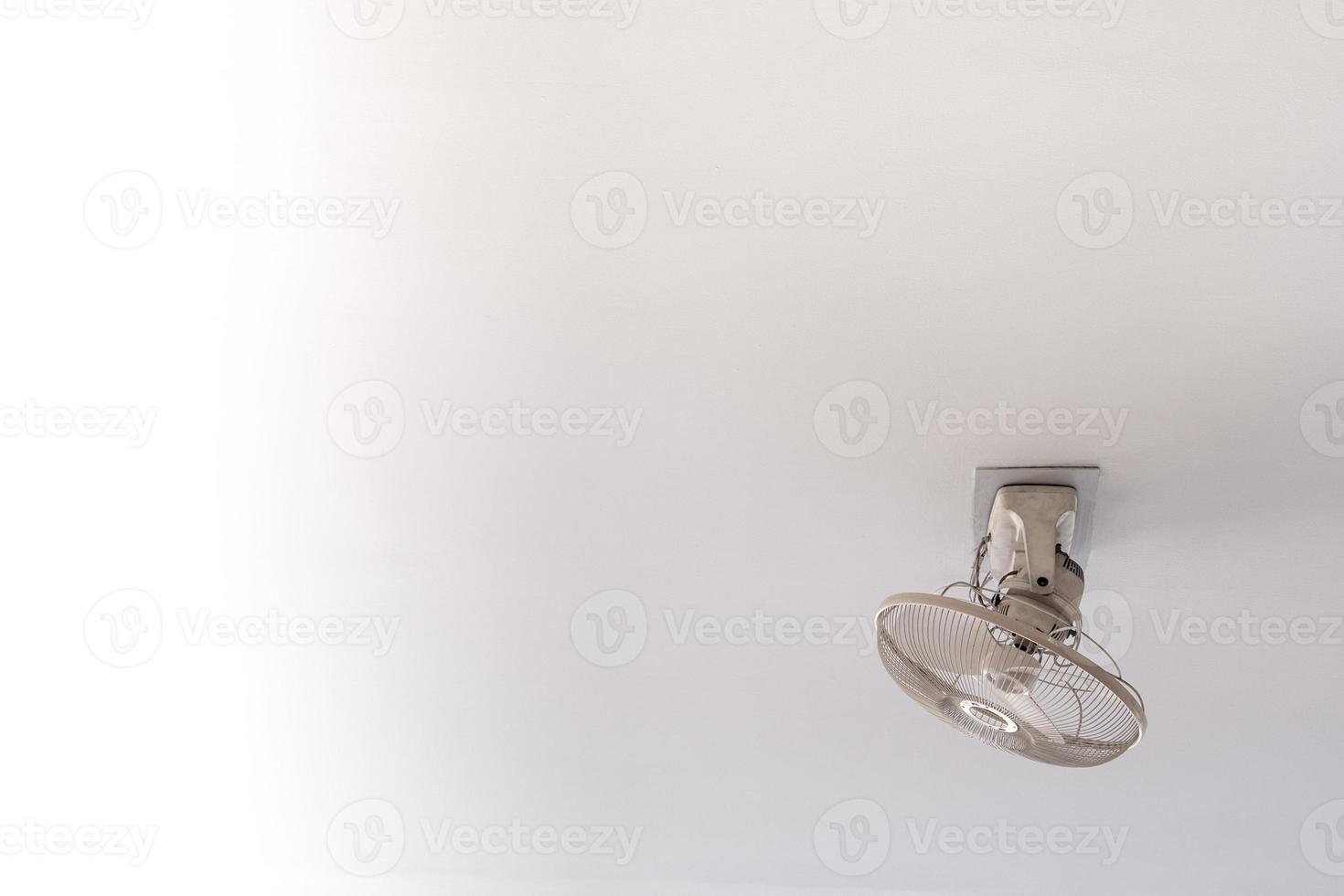 White Orbit ceiling fan on the ceiling of white room photo