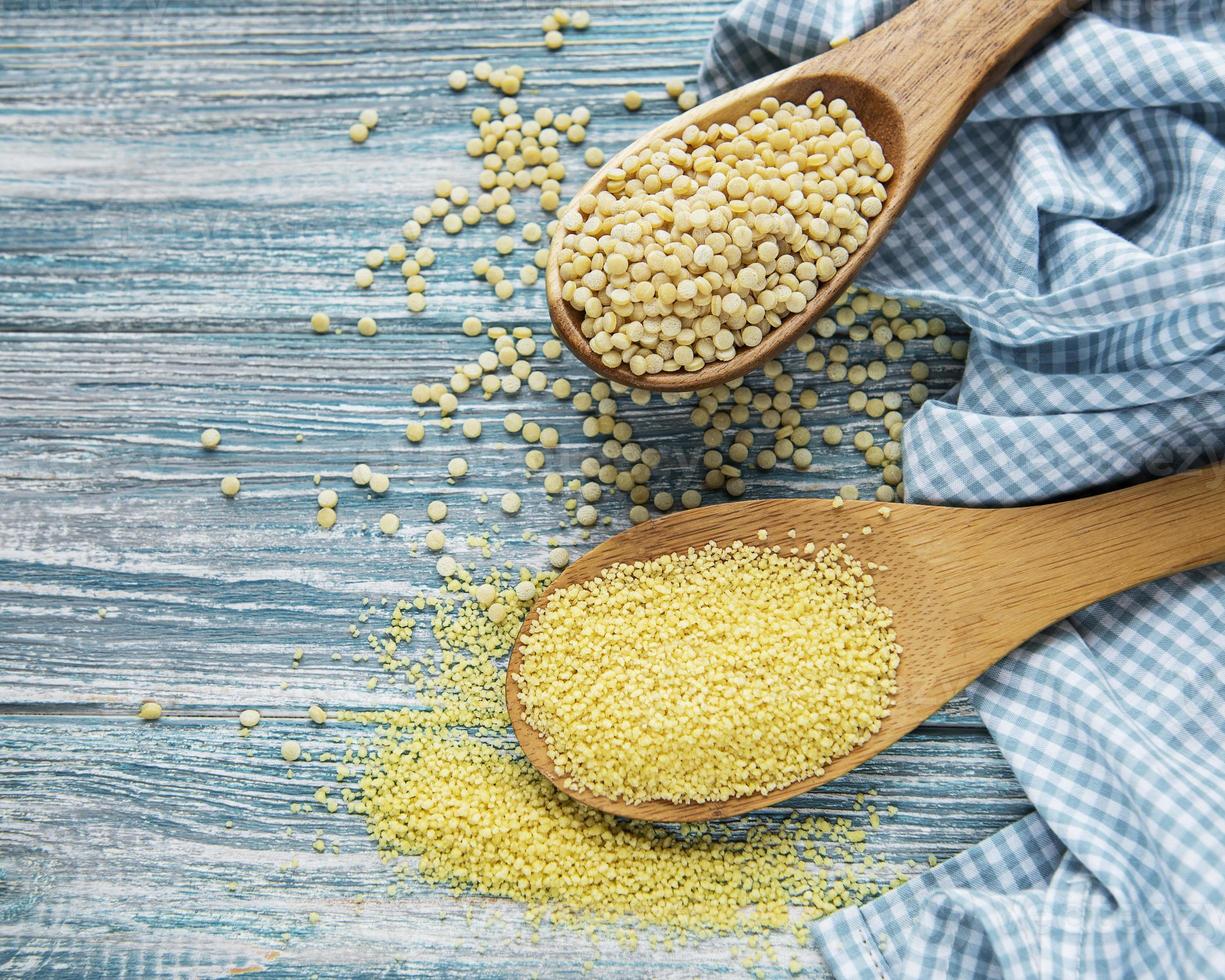 Raw Couscous on table photo