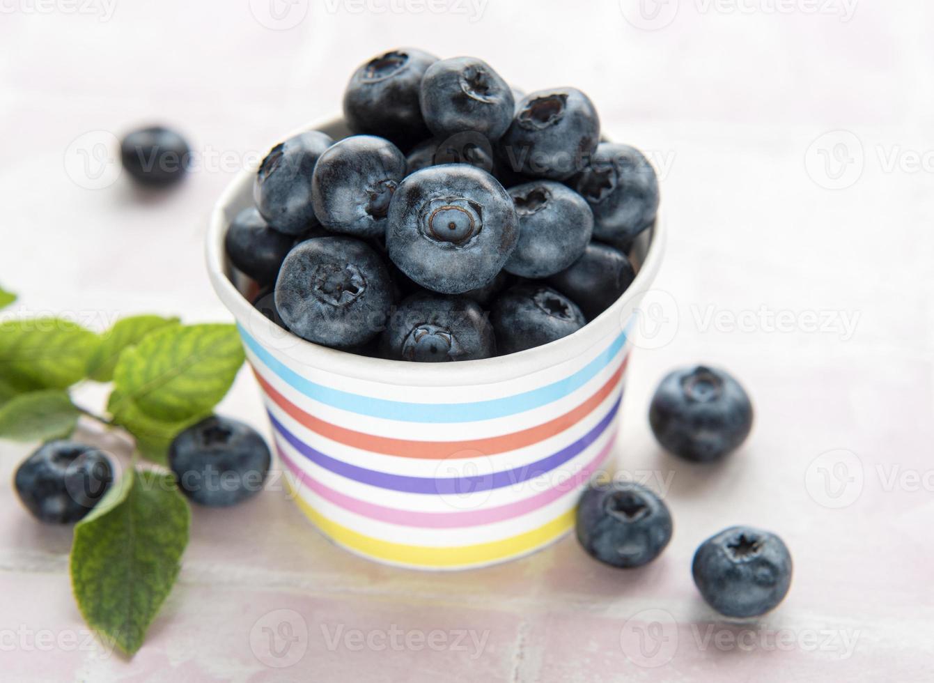 Blueberries on tile background photo