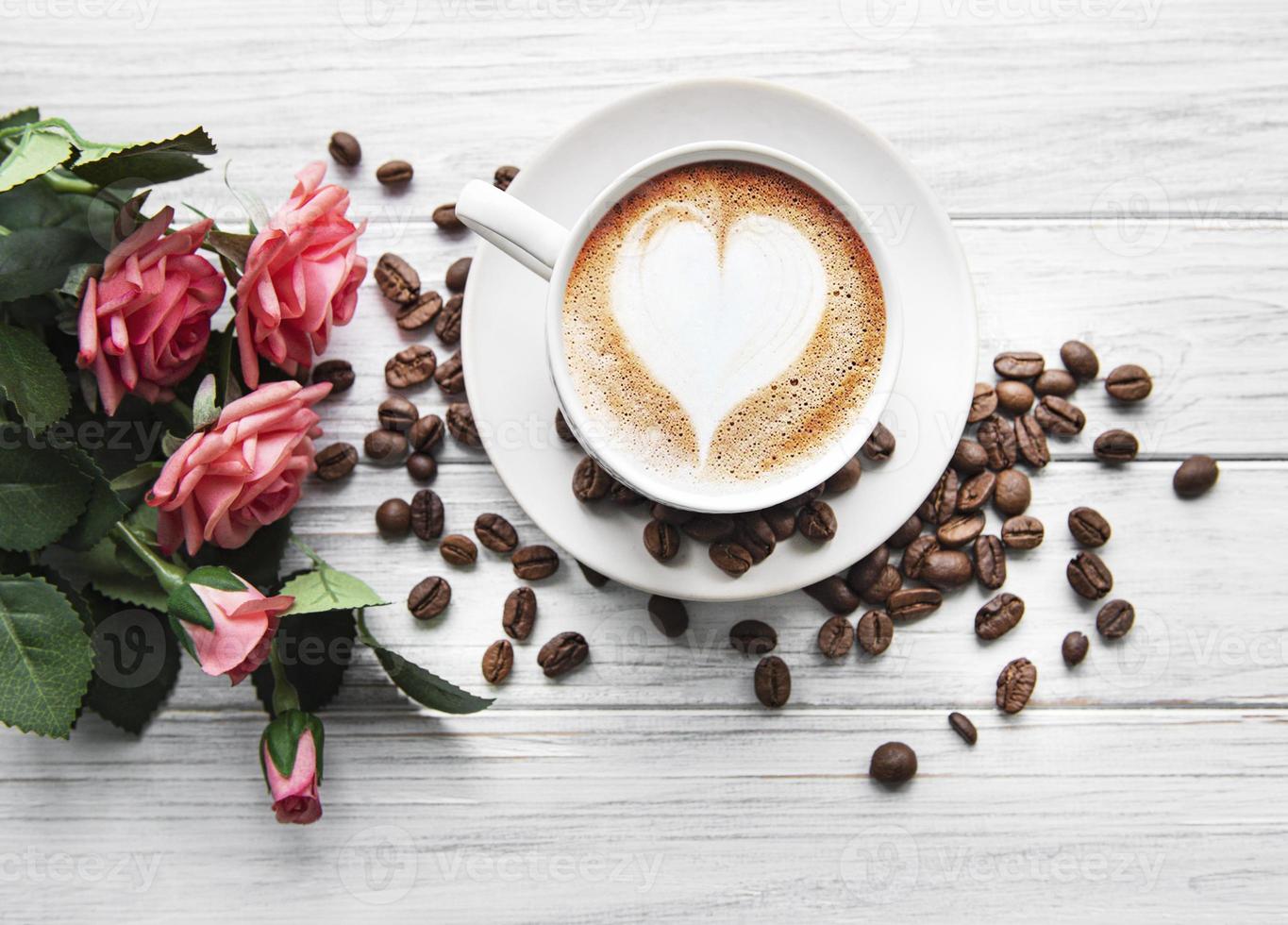 una taza de café con patrón de corazón en una mesa foto