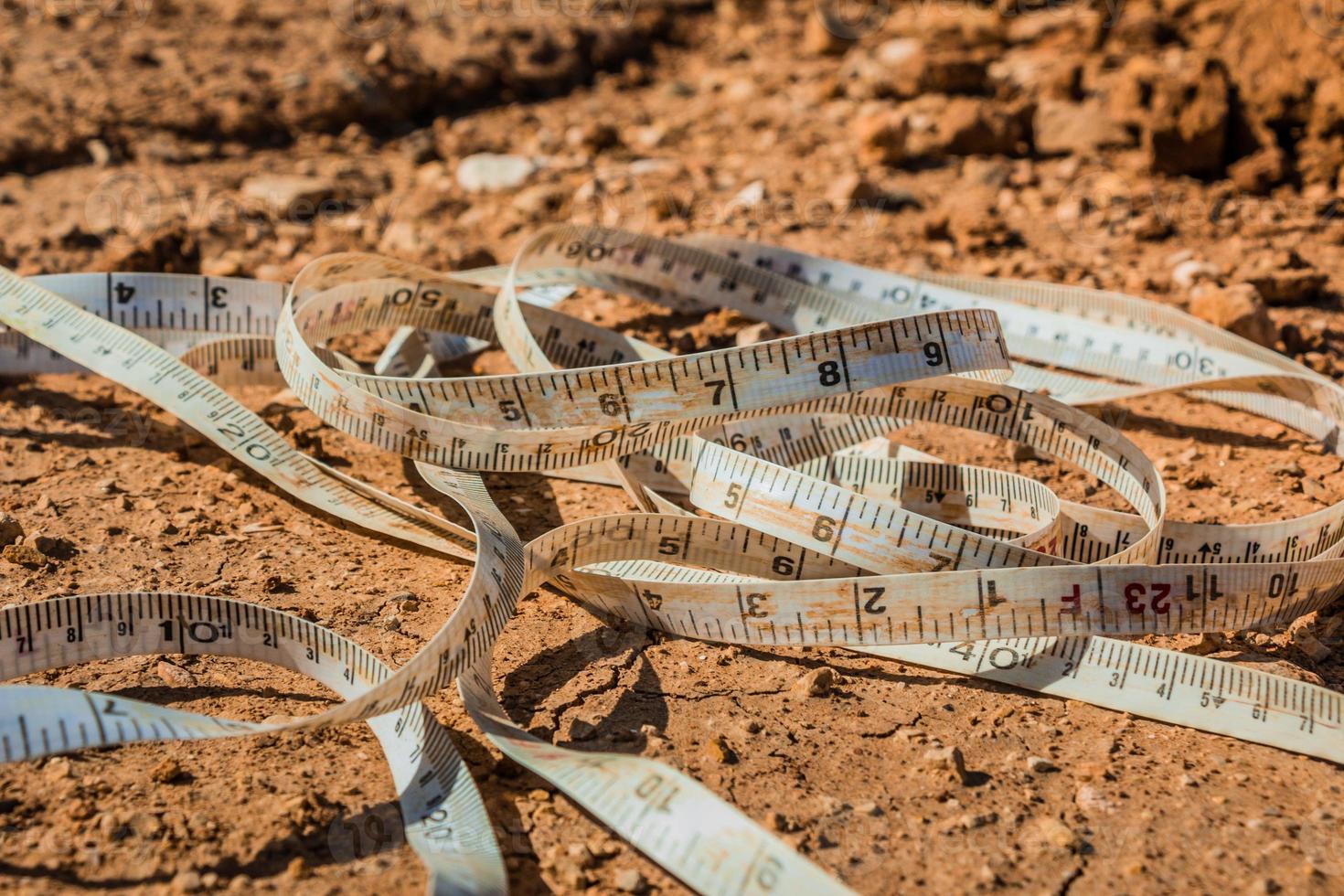 Measuring tape placed on the ground at a construction site photo