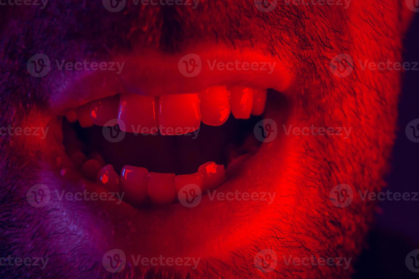 Macro close up on man with happy smiling facial expression photo