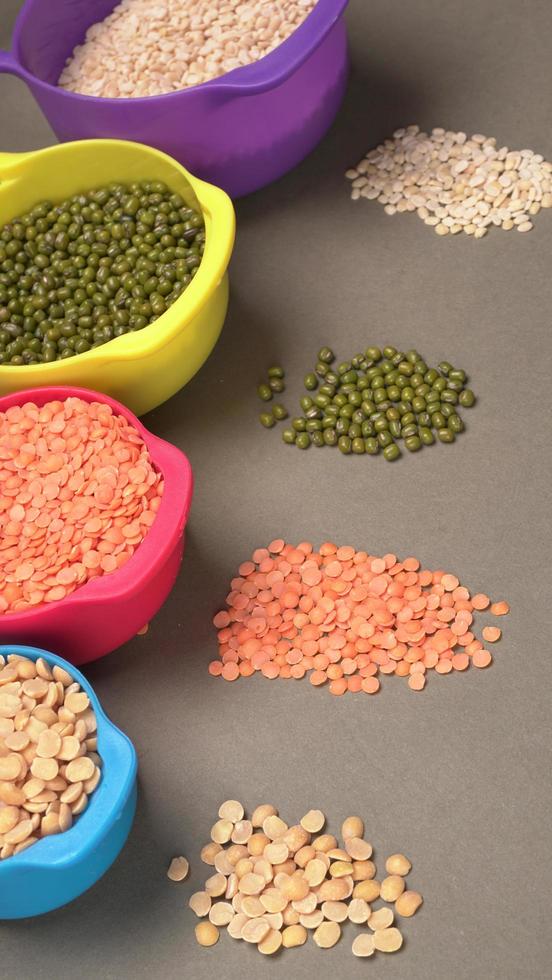 Uncooked pulses,grains and seeds in bowl over grey background. selective focus photo
