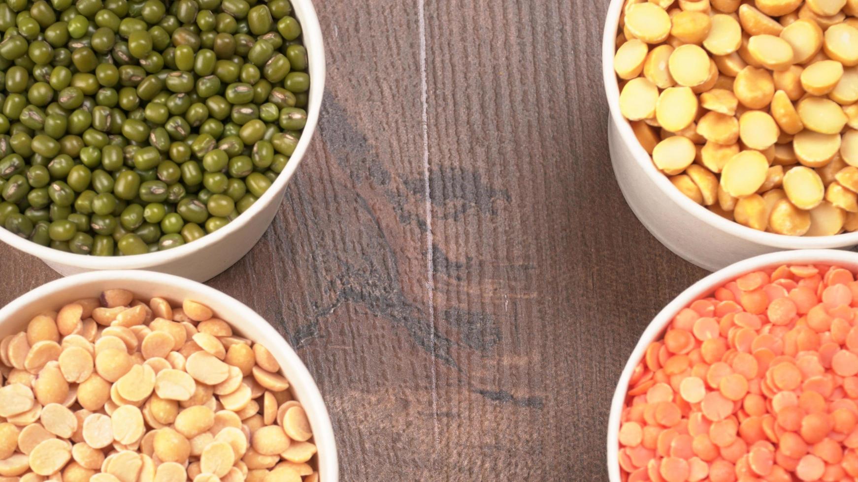 Uncooked pulses,grains and seeds in bowl over grey background. selective focus photo