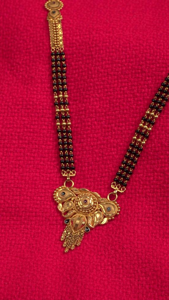 Mangalsutra or Golden Necklace to wear by a married hindu women, arranged with beautiful backgrond. Indian Traditional Jewellery. photo