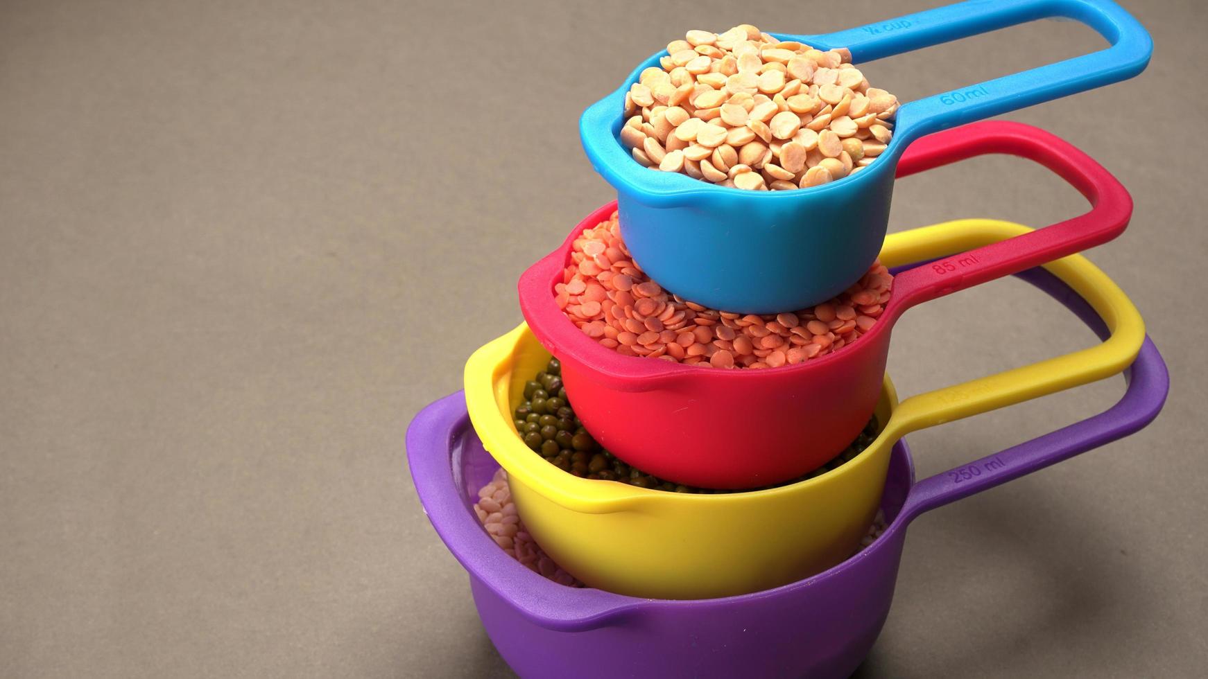 Uncooked pulses,grains and seeds in bowl over grey background. selective focus photo