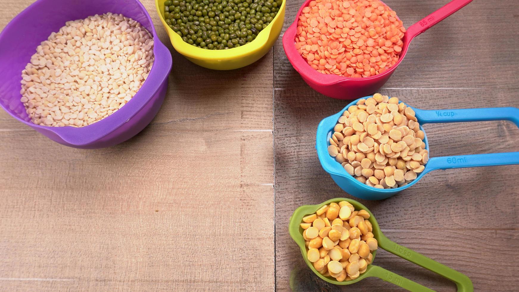 Uncooked pulses,grains and seeds in bowl over grey background. selective focus photo