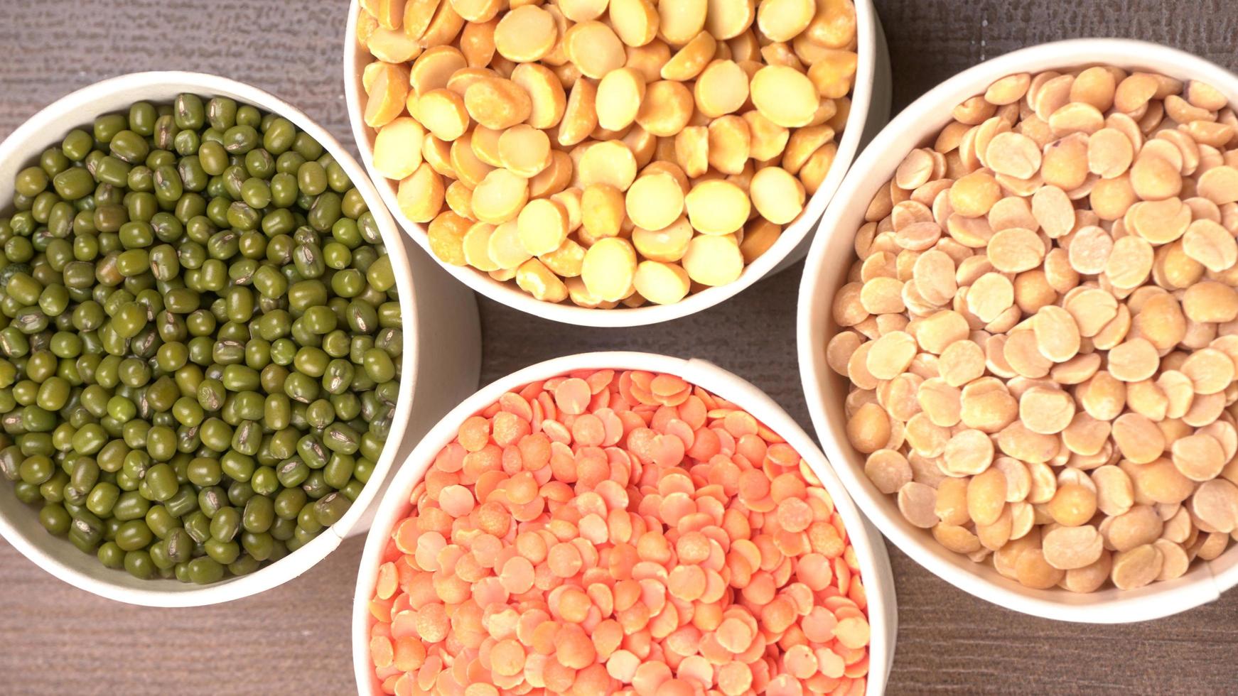 Uncooked pulses,grains and seeds in bowl over grey background. selective focus photo