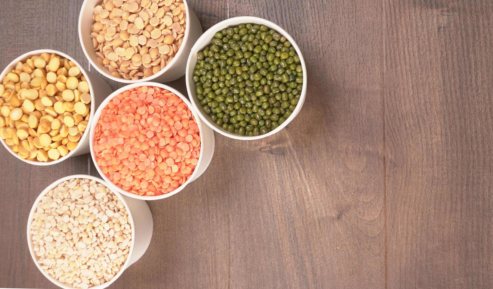 Uncooked pulses,grains and seeds in bowl over grey background. selective focus photo