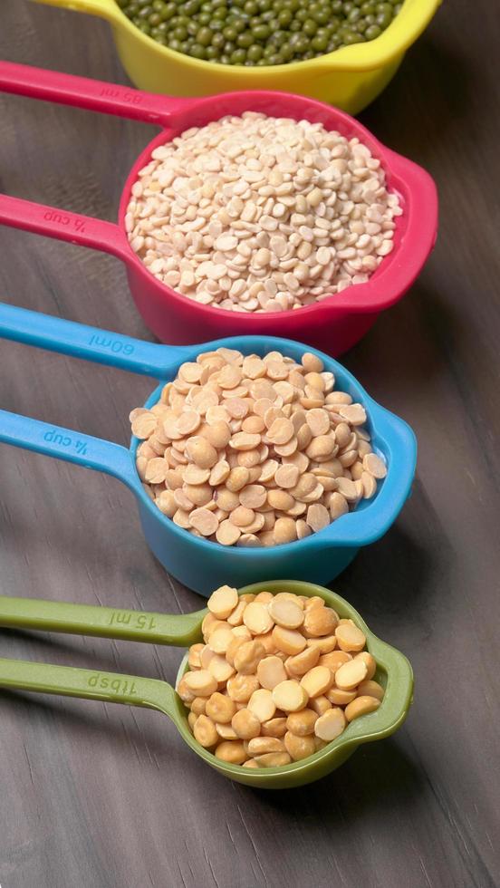 Uncooked pulses,grains and seeds in bowl over grey background. selective focus photo