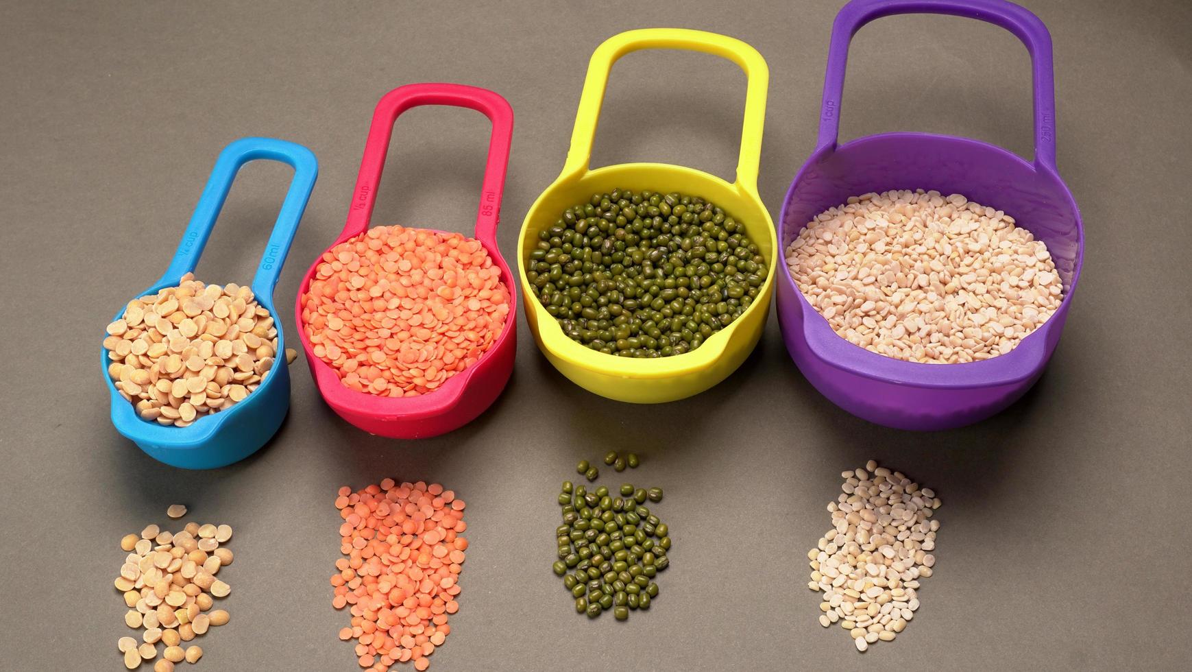 Uncooked pulses,grains and seeds in bowl over grey background. selective focus photo