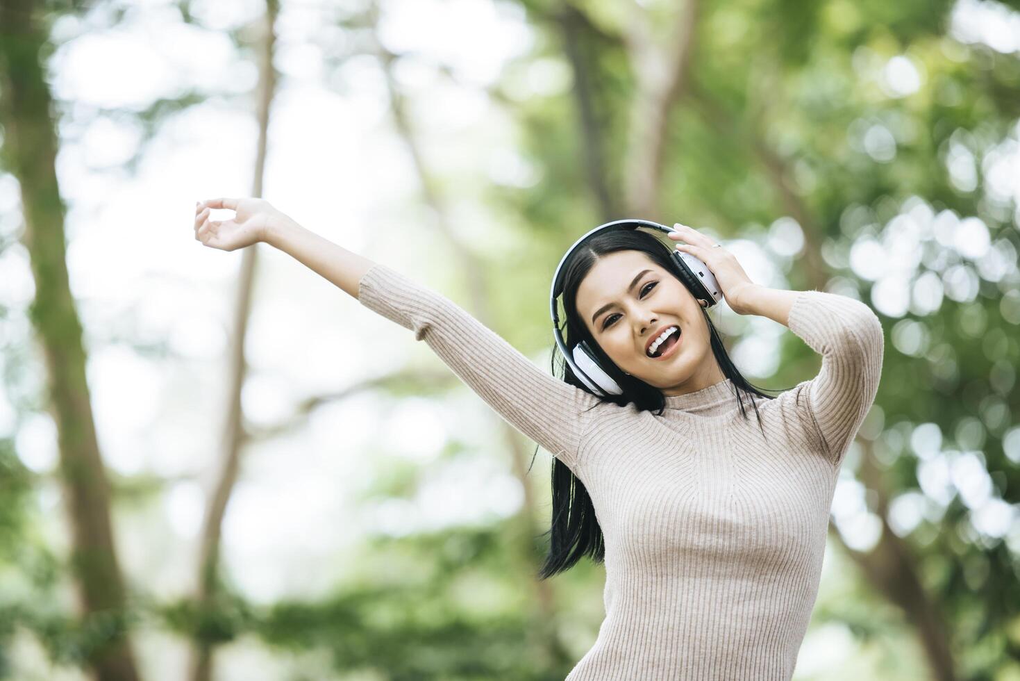 Asian woman listening favorite music on headphones. Happy time and relax. photo