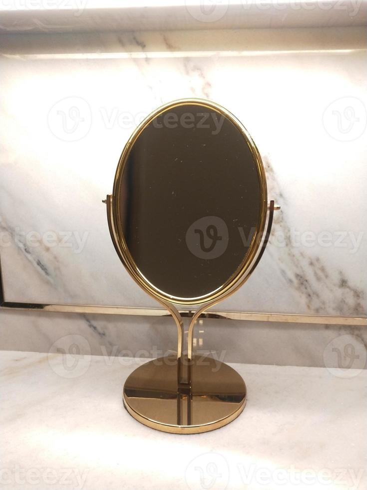 makeup mirror photo with gold frame and marble background