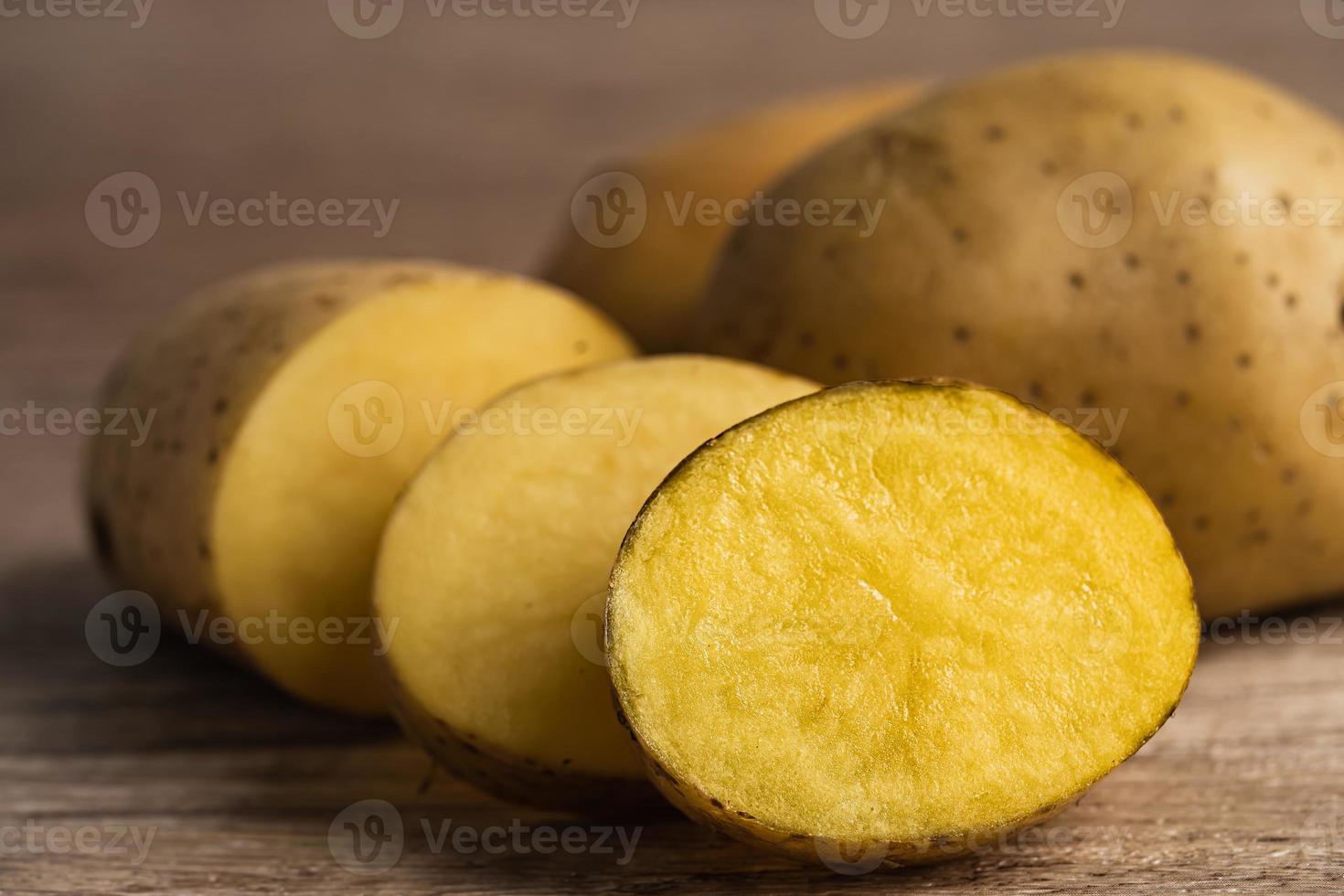 Potato raw and fresh vegetable food on wooden background. photo