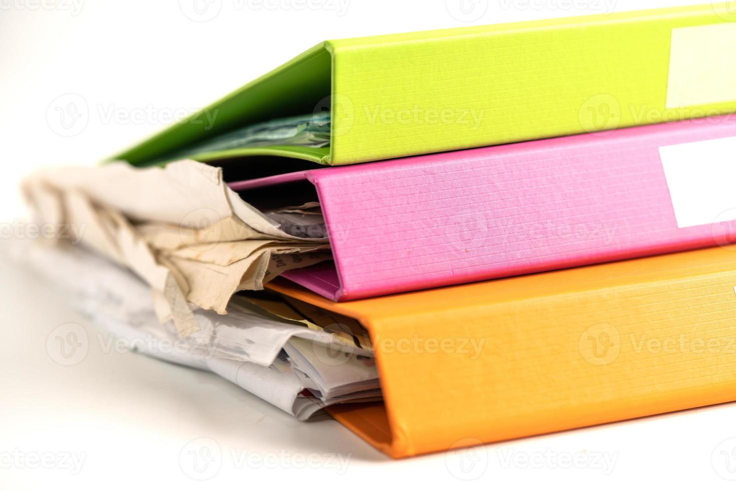 File Folder Binder stack of multi color on table in business office. photo