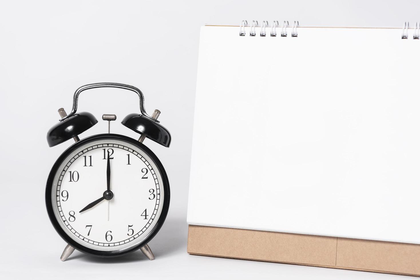 Blank paper spiral calendar for mockup template advertising and branding with clock on gray background. photo