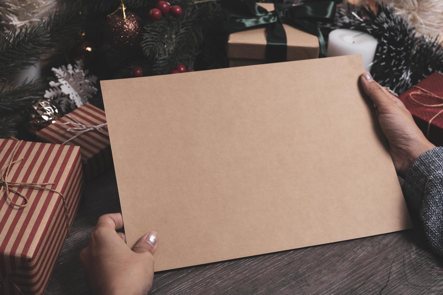 Christmas holiday greeting paper design mockup with decoration on wood table. photo