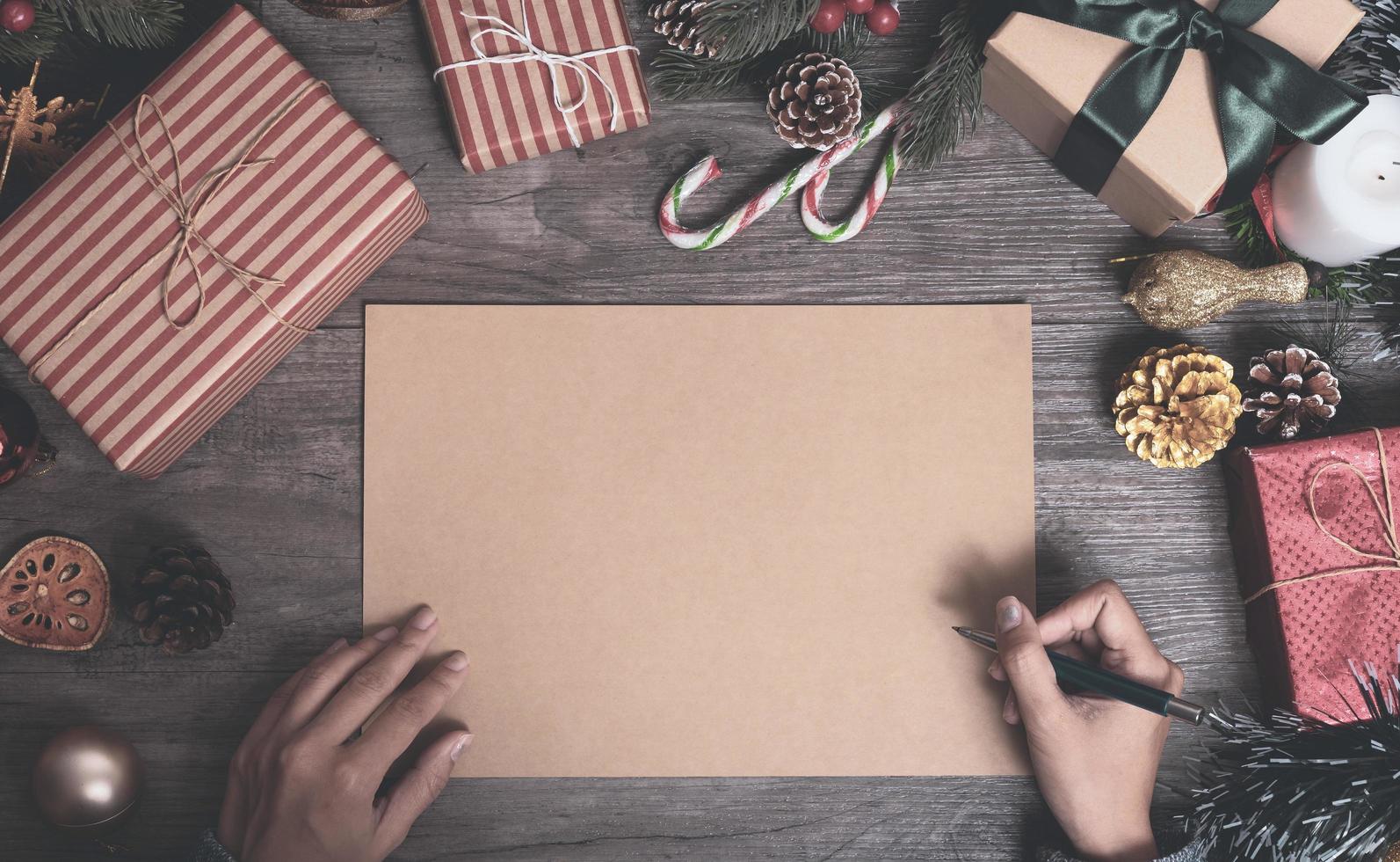 Christmas holiday greeting paper design mockup with decoration on wood table. photo