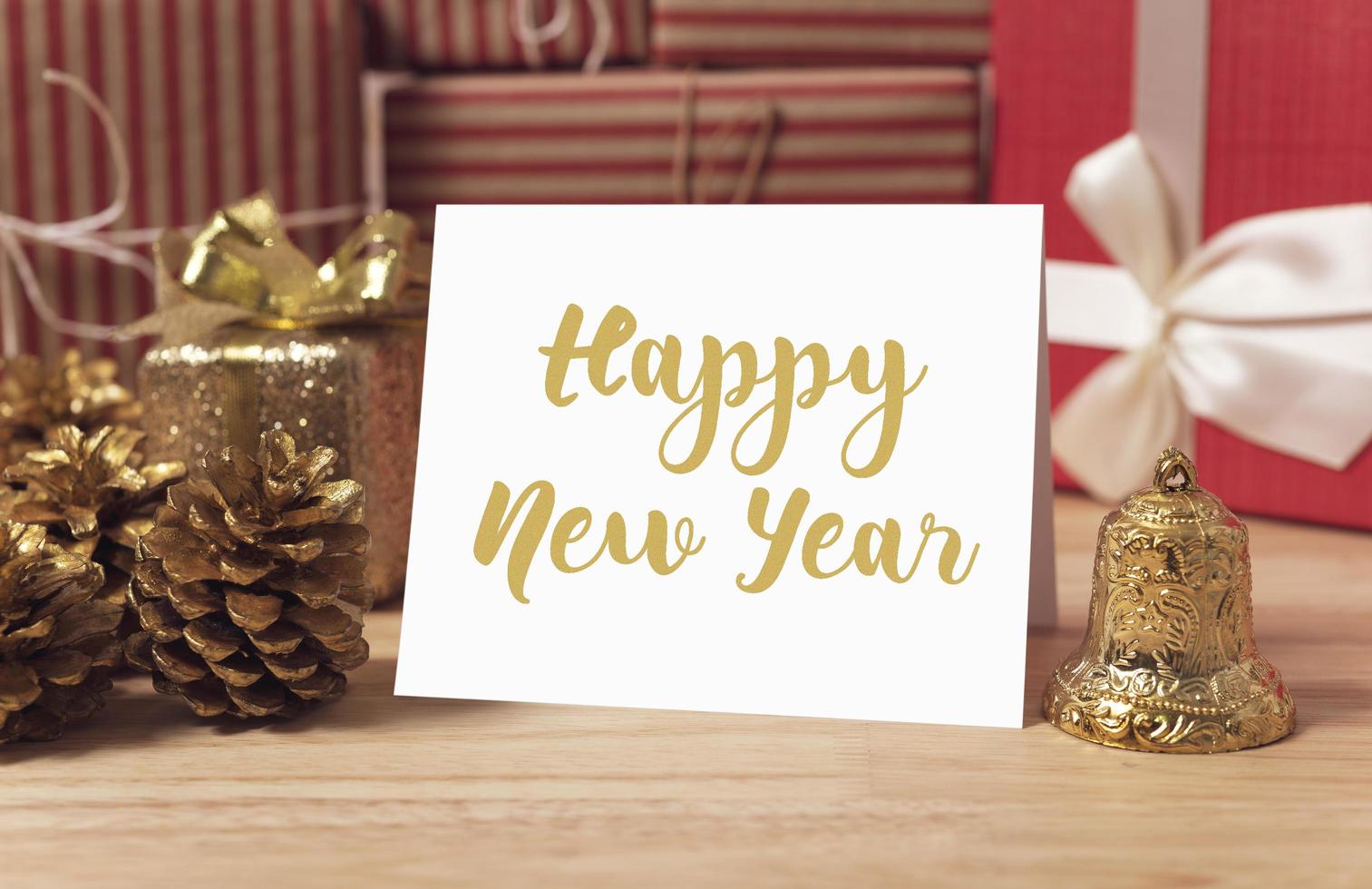 Happy new year holiday greeting paper card design mockup with decoration on wood table. photo