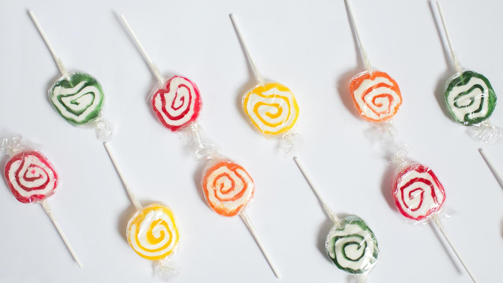 Colorful pattern with lollipops and white background photo