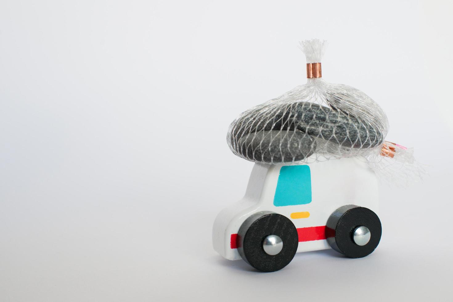 Close up of an ambulance toy carrying a heavy load. Conceptual for the efforts that health systems are doing during COVID photo