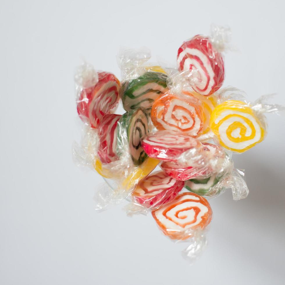 Handful of colorful lollipops seen from above. Red, green, yellow and orange. photo