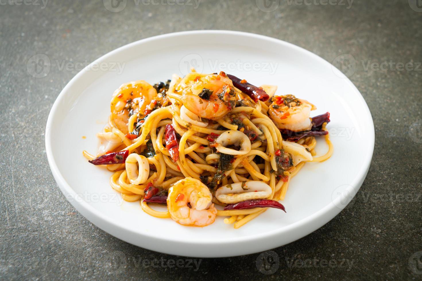 spicy spaghetti seafood on plate photo