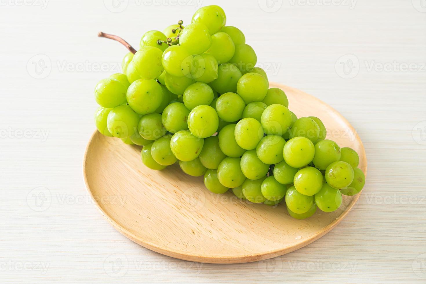 fresh green grape on wood plate photo