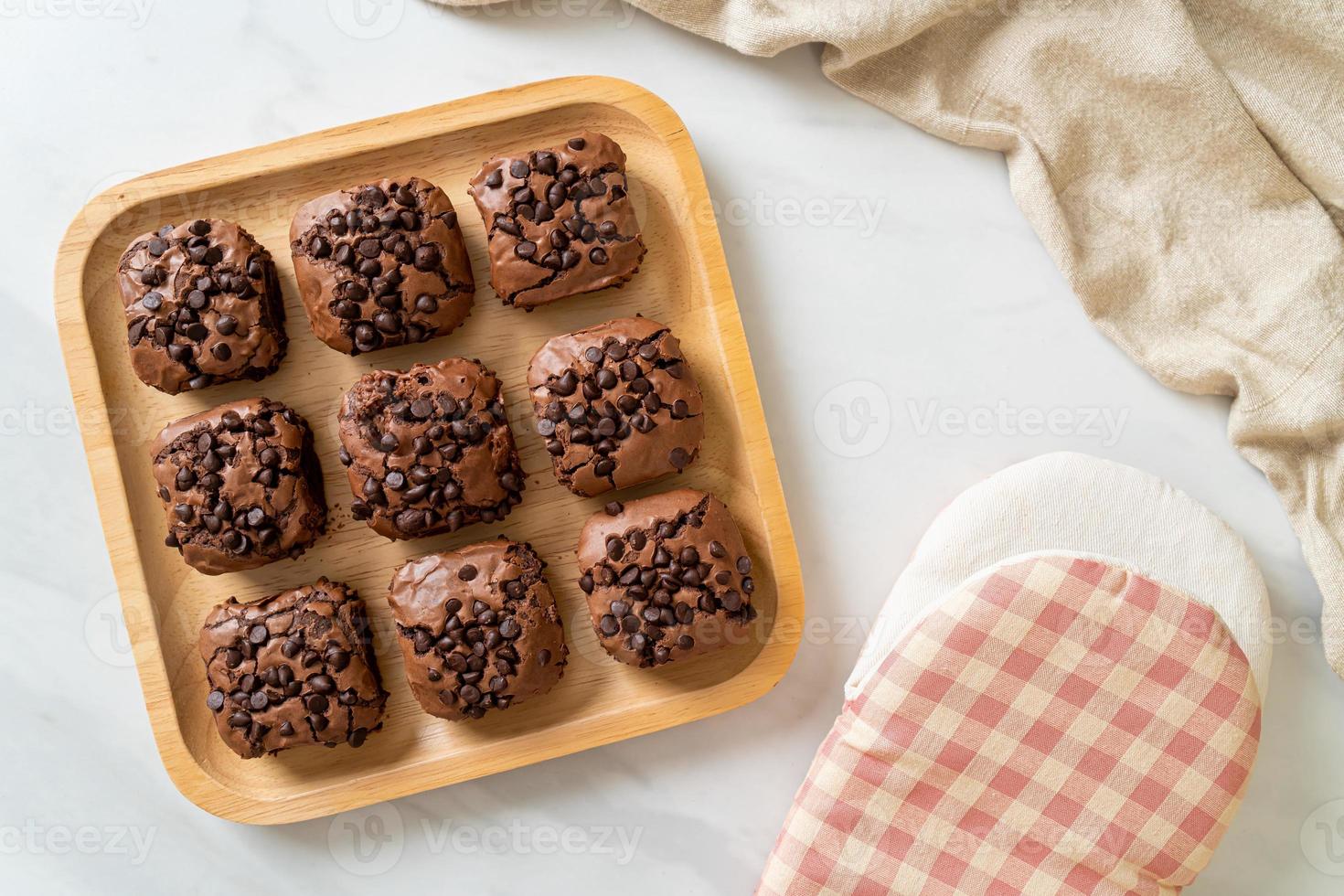 dark chocolate brownies topped by chocolate chips photo