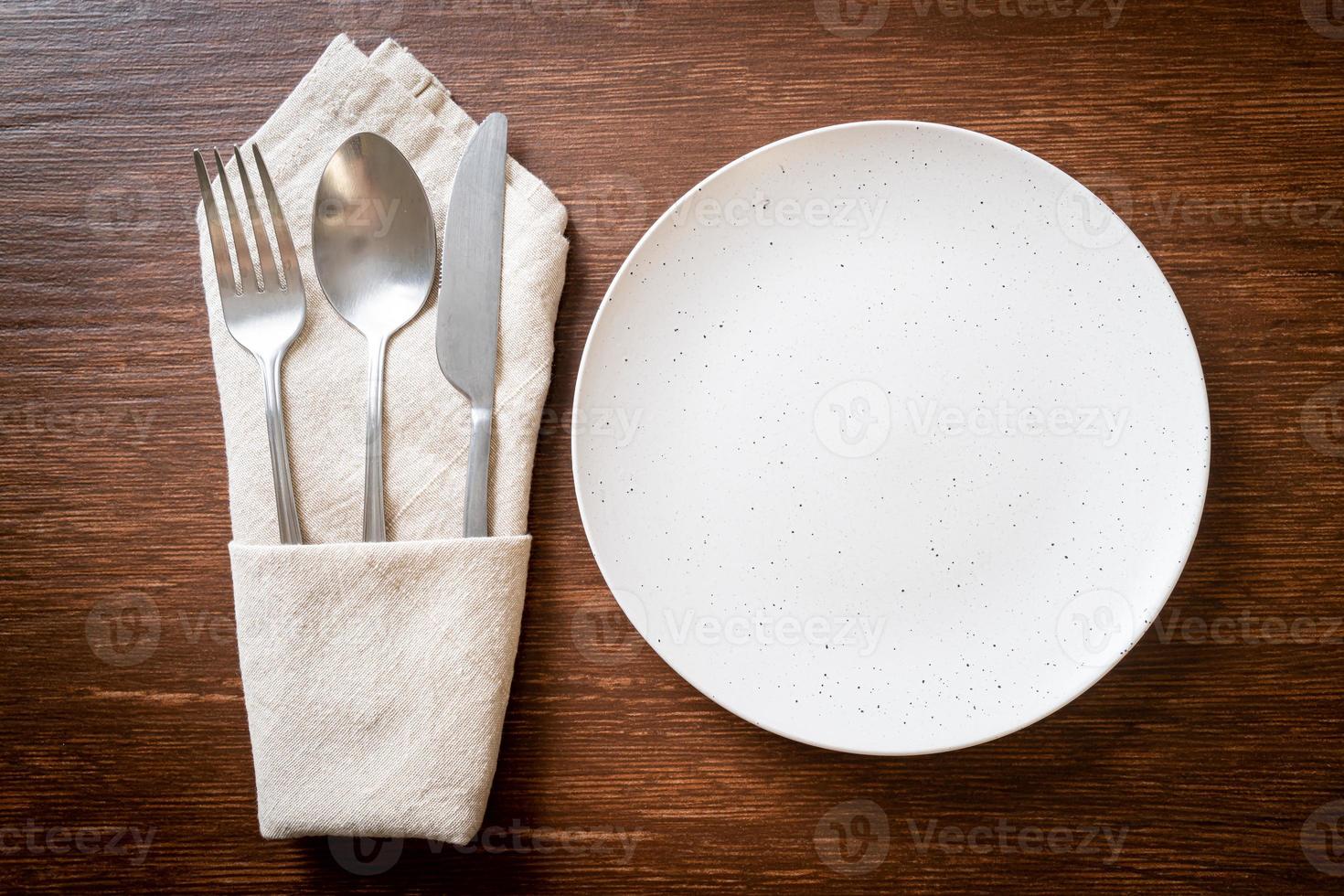 empty plate or dish with knife, fork and spoon photo