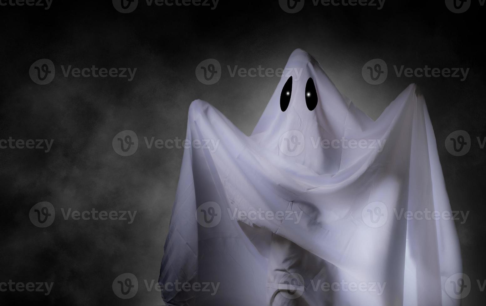 Scary white ghost at big eye for Halloween concept with clipping path photo