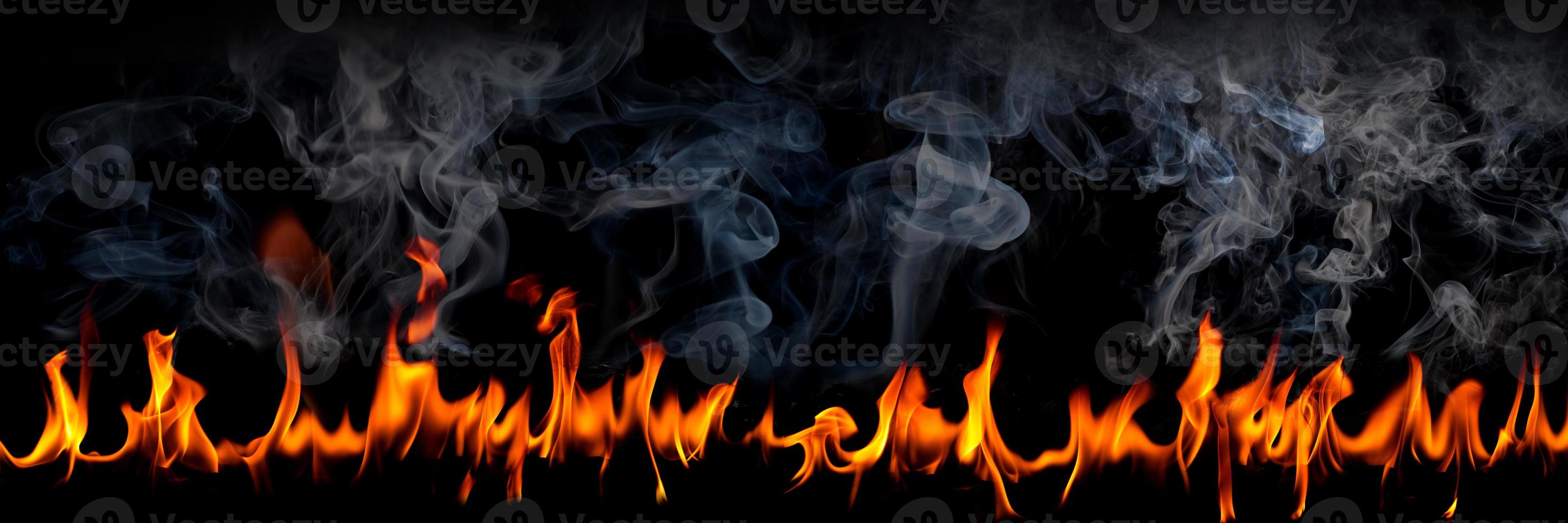 Fire flames with smoke on black background, Burning red hot sparks rise, Fiery orange glowing flying particles photo